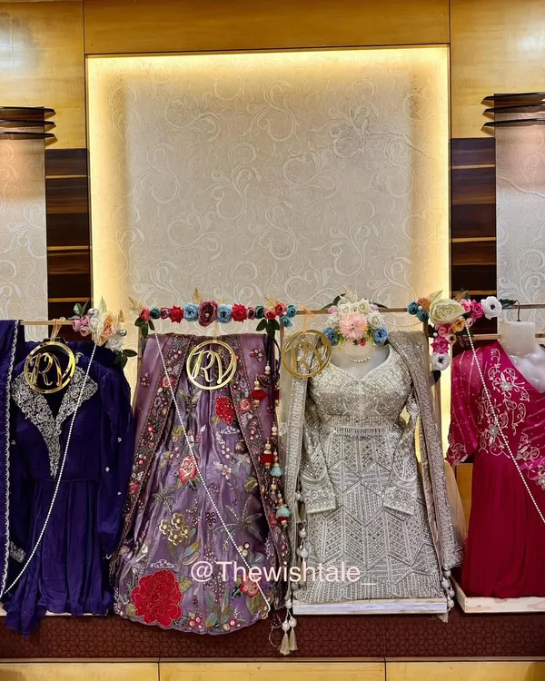 This is my happy place, surrounded by gorgeous wedding outfits! I specialize in trousseau packing, making sure every single piece, from heavy lehengas to delicate suits, is presented beautifully with custom floral arrangements and personalized initial tags.