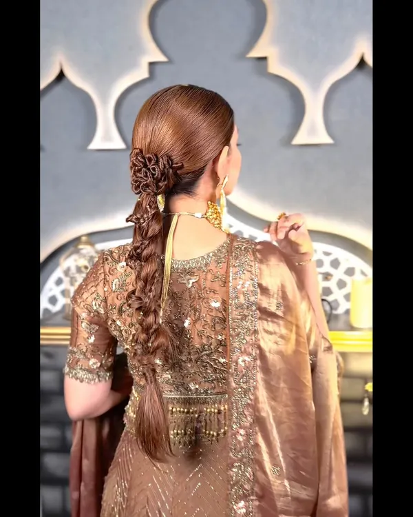 A true masterpiece. This intricate braid combines multiple weaving techniques and is finished with a floral-style bun at the top, creating a hairstyle that is both a braid and a work of art.