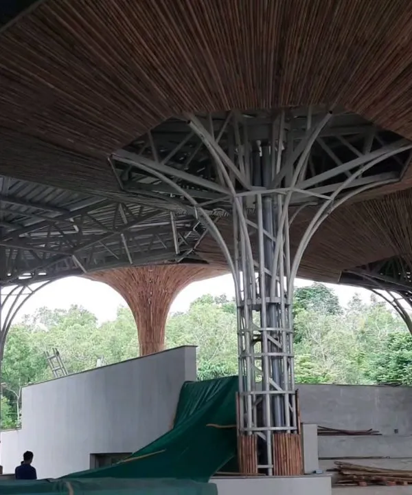 The bamboo parasols at the TAPMI Centre are a testament to our collaborative process. This image shows the intricate steel framework being clad with individual bamboo pieces, a process that combines modern engineering with traditional craftsmanship.