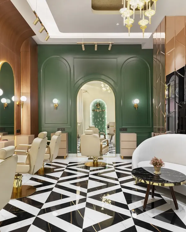 A glimpse into a luxury makeup atelier we designed in Gurgaon. The space combines bold geometric flooring with rich emerald green walls and warm wood paneling, creating an atmosphere of opulence and artistry that reflects the brand's identity.