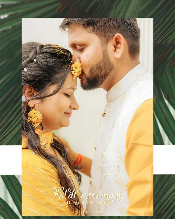 A sweet, intimate moment during a Haldi ceremony. The groom applies haldi to the bride's forehead, and the close-up shot captures the tenderness and tradition of the ritual.
