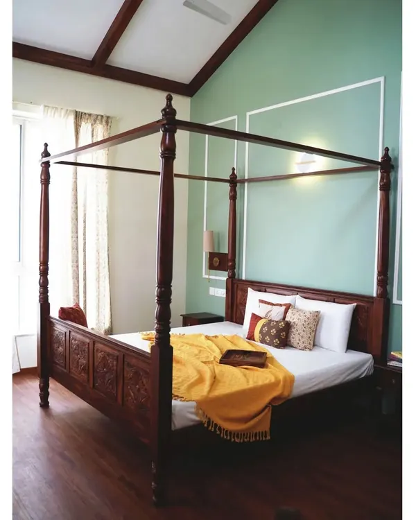 This magnificent four-poster Sheesham bed is the heart of a master bedroom designed for peace and tranquility. The exquisite carving on the headboard and the beautifully turned bedposts showcase our commitment to traditional Indian craftsmanship, creating a timeless centerpiece for a modern home.