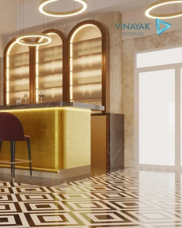 This modern home bar is designed for entertaining in style. The gold mosaic tiles on the bar front, combined with the sleek black marble top and halo-like pendant lights, create a glamorous and inviting atmosphere.