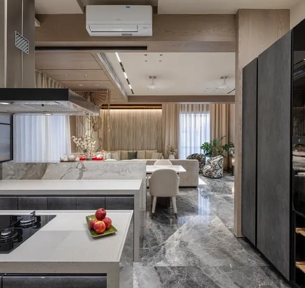 This open-plan kitchen is designed to be the social hub of the house. From the cooking area, you have a clear view of the living room, making it easy to interact with family and guests. The tall ceramic-finish unit houses the oven and provides ample storage.