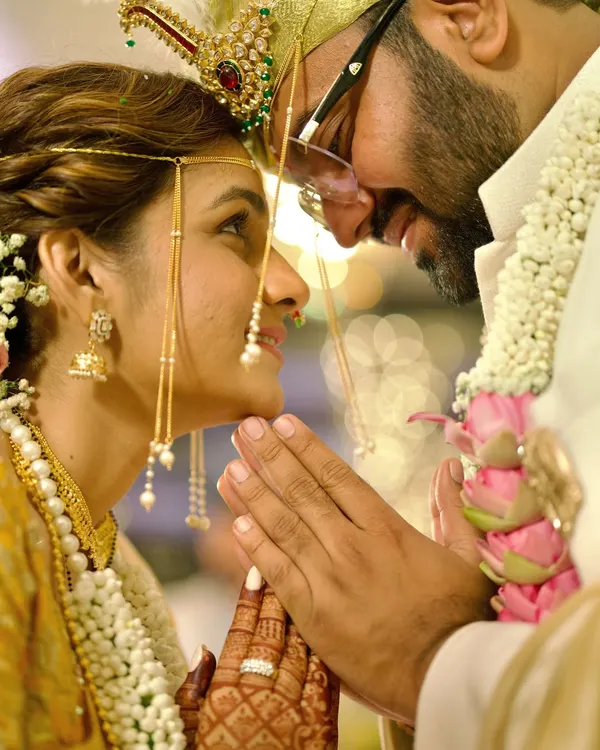 The beauty of tradition lies in its quiet moments. This close-up from a Marathi wedding captures the gentle intimacy and deep respect between the couple during a sacred ritual. We believe these are the frames that hold the most emotion and become timeless memories.