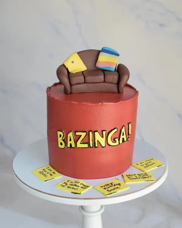 Bazinga! A fun cake for a fan of The Big Bang Theory. The design features the iconic couch as a topper and Sheldon's famous catchphrase, with memorable quotes on sticky notes.