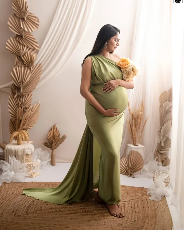 This full-length portrait showcases a beautiful olive green gown against my boho-inspired set, featuring dried palm leaves, a jute rug, and soft, natural light.