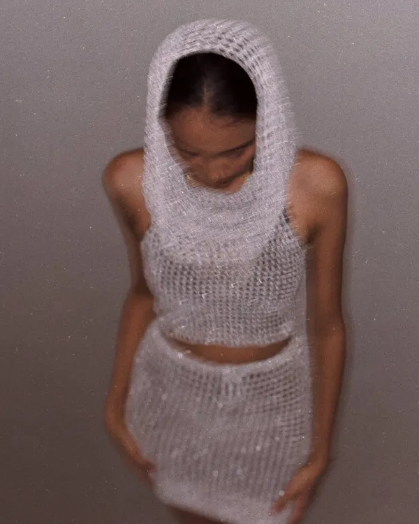 A full look at the shimmering hooded mesh set. The cowl neck is designed to be super versatile, and the open-weave stitch is perfect for layering.