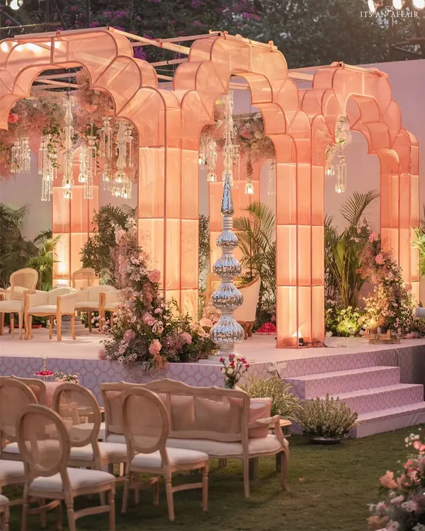 A modern interpretation of a royal Indian garden, this glowing organza mandap creates a magical, ethereal atmosphere for an evening wedding ceremony.
