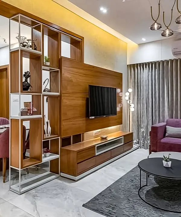 We designed this open-plan living and dining area using a clever partition that doubles as a display unit. The wooden TV unit features clean lines and low-profile storage, seamlessly connecting the two spaces while maintaining a sense of openness.