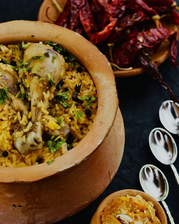 Our signature chicken biryani, slow-cooked to perfection in a traditional clay pot. We prepare it over a wood fire, a method that infuses the rice and meat with a distinct smoky flavour you won't find anywhere else.