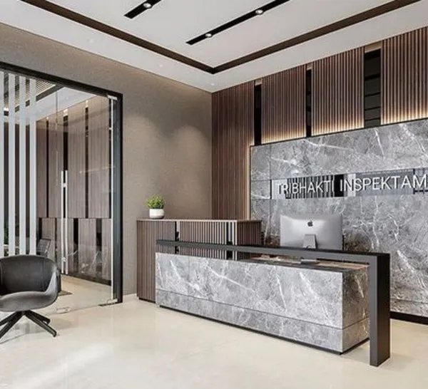 A powerful and modern office reception featuring a grey marble desk and matching accent wall with a bold company logo. The design uses dark wood slats and glass partitions to create a sophisticated and professional corporate entrance.