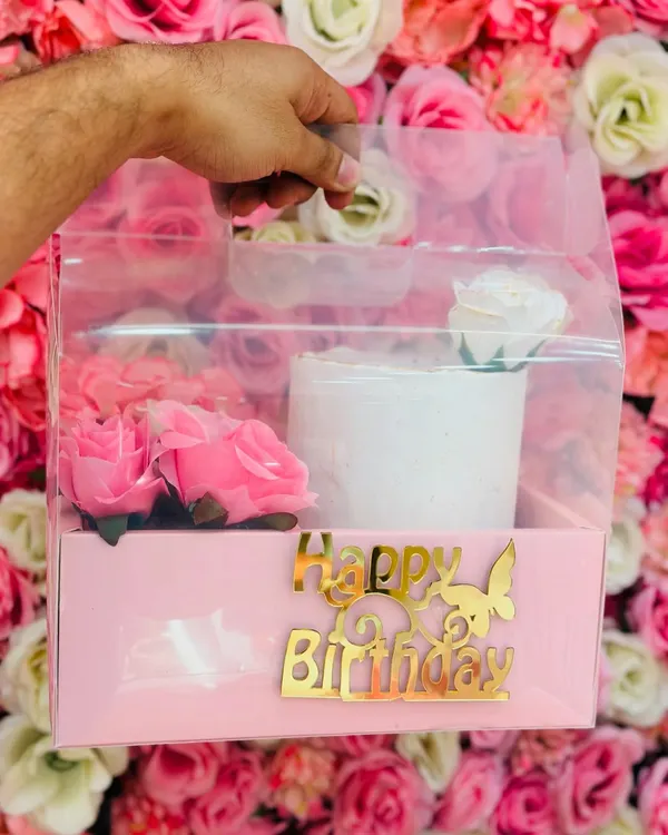 This is my signature birthday hamper, designed to make gifting simple and special. It features a half-kg tall cake, fresh flowers, and a golden 'Happy Birthday' topper, all beautifully packaged.