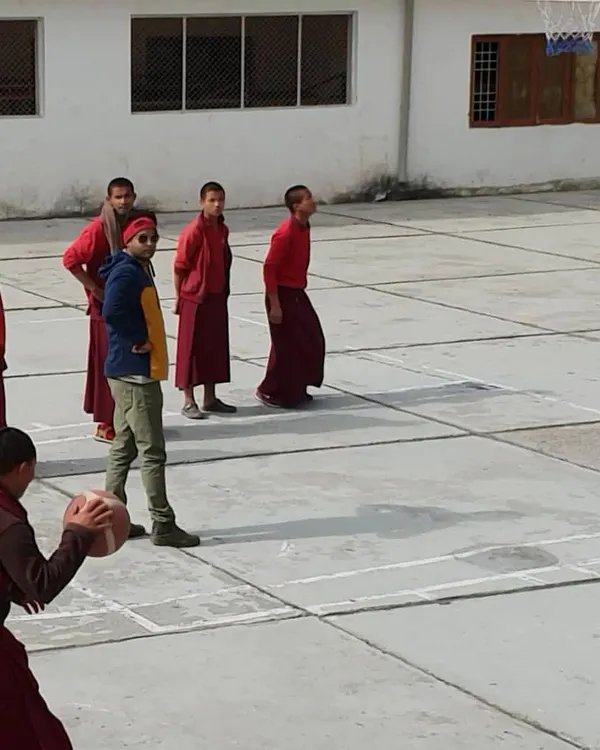 Basketball has no boundaries. This impromptu coaching session during a monastery visit was a truly special experience, sharing the fundamentals of the game with a group of enthusiastic young monks.