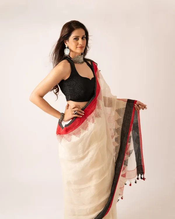 A saree is a story woven in six yards of grace. This image from a brand shoot for a saree company showcases the elegant drape and intricate details of the fabric.