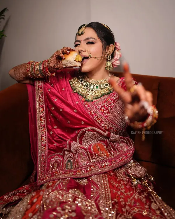 A fun and real moment of the bride enjoying a snack in her full wedding attire. It's these candid, unscripted shots that make memories.