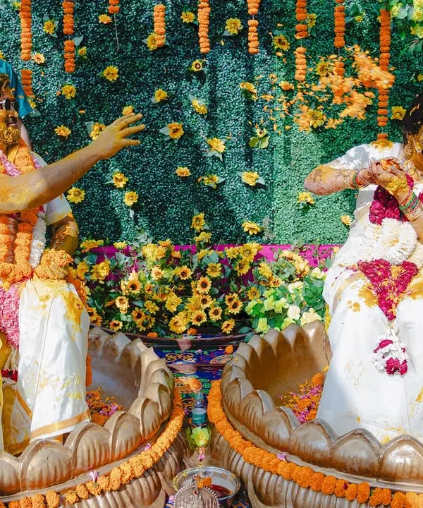 Pure, unadulterated fun during a South Indian Haldi ceremony. The couple's playful antics and sunglasses add a modern twist to the tradition.