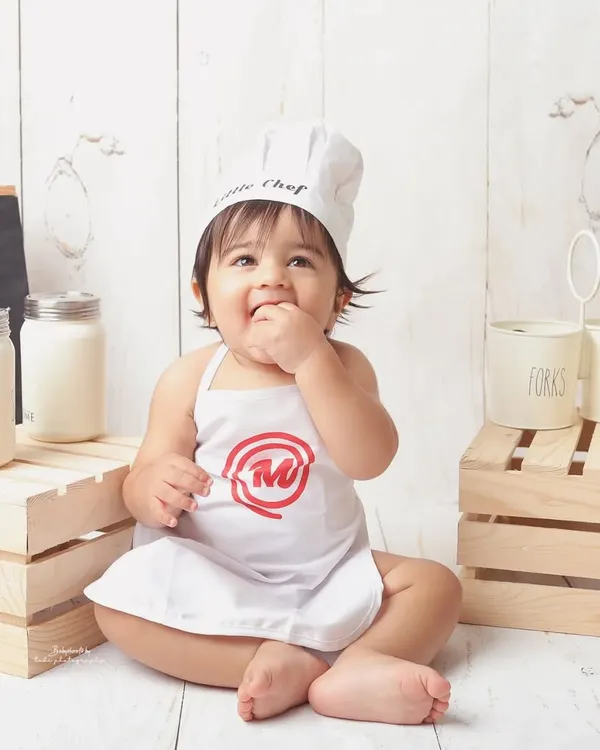 Meet the little chef. This themed shoot is one of my most popular, and it's easy to see why. The tiny apron, chef's hat, and kitchen-themed props create an unbelievably cute and memorable scene.