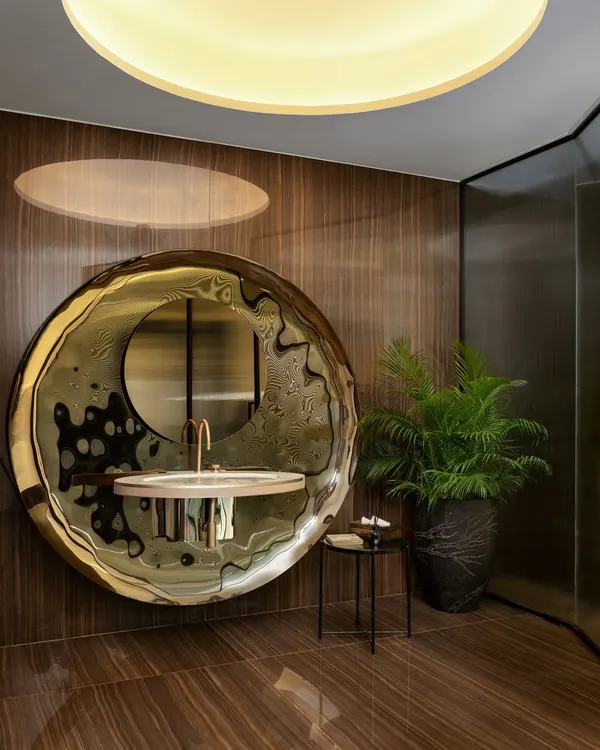 A washroom where elegance meets artistry. The sink, a breathtaking showstopper, stands as a testament to refined taste, while the exquisite Italian tiles from Fiandre weave a harmonious tapestry of design.