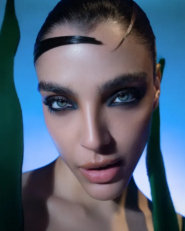 An extreme close-up from a high-fashion beauty shoot. The focus is on the intense, smoky eye makeup and flawless skin, demonstrating my skill in capturing detailed beauty work.