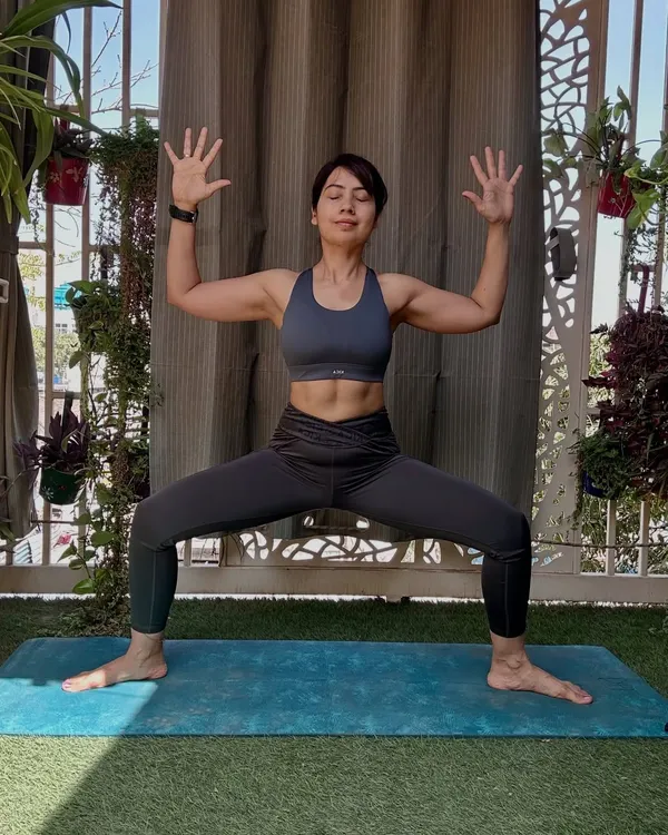 The Goddess Pose, or Utkata Konasana, is a powerful stance for building lower body and core strength. As you can see from my defined core, this pose engages the entire midsection. It grounds your energy, fires up your inner thighs and glutes, and opens the hips.