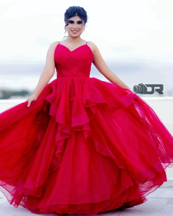 This stunning red ballgown is one of my signature pieces. The layered tulle skirt and fitted bodice create a classic princess silhouette, perfect for making a grand entrance.