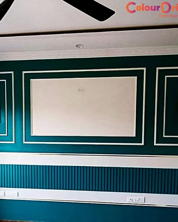 An elegant living room wall featuring a deep teal paint complemented by crisp white beading. We expertly paint both walls and MDF or solid wood beading to create a sophisticated, layered look with a perfect, professional finish.