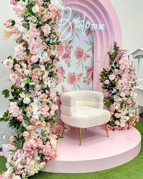 This dreamy "Bride to Be" setup is one of my most requested designs. The pastel pink arch, cascading flowers, and vintage-style props create a whimsical and romantic backdrop for a bridal shower or mehendi.