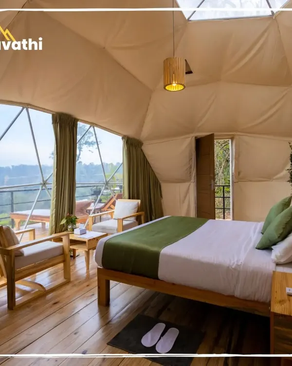 The interior of a Geodesic Dome at Hypnotic Stays, Wayanad. The large panoramic window lets you wake up to incredible views of the tea estates right from your bed.