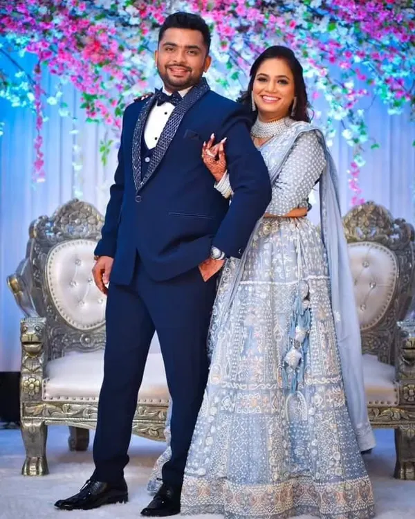 A perfectly tailored groom's tuxedo for a perfect day. This custom blue three-piece features intricate beadwork on the lapel, designed to stand out in your wedding photos.