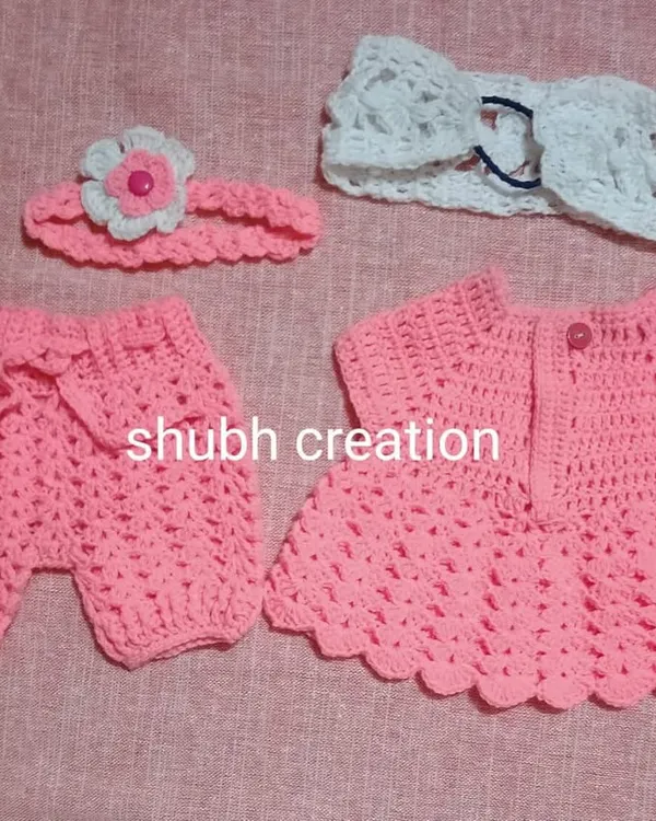 A complete outfit for a baby girl, this set includes a pink crochet dress, matching shorts, and two different handmade headbands for a coordinated look.
