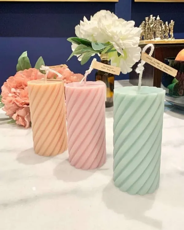 My spiral pillar candles in soft pastel shades. These are a great way to add a touch of modern elegance and color to your living room or bedroom decor.