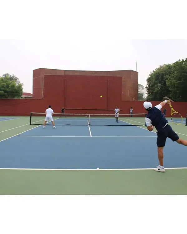 A player unleashes a powerful forehand during a match on our courts. The high-quality playing surface and professional setup are ideal for competitive tennis tournaments.