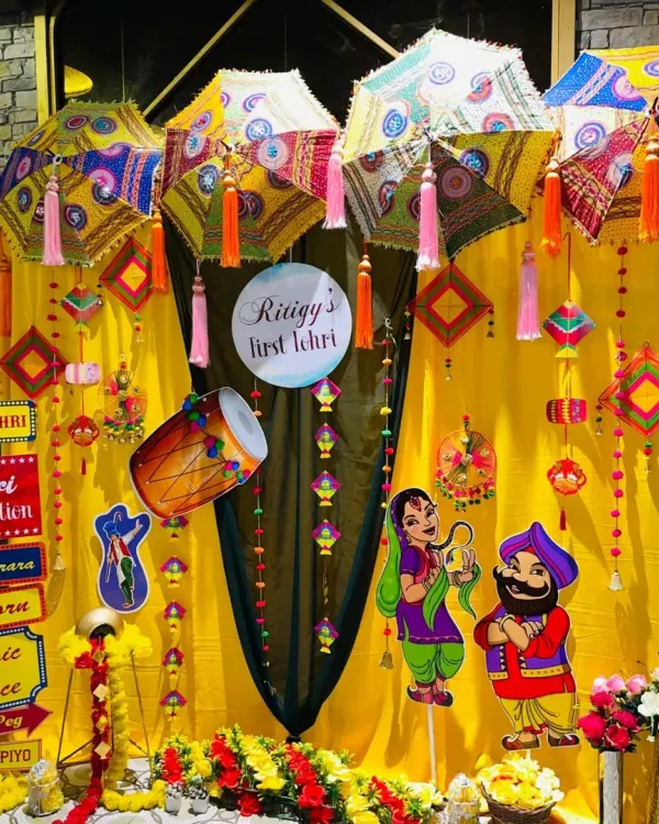 This is one of my favorite setups for a baby's first Lohri celebration. I used bright yellow drapes, traditional Punjabi umbrellas, and fun cutouts to create a perfect photo corner full of festive energy.
