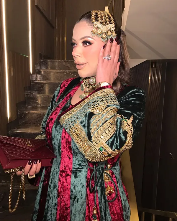 A side profile showcasing the stunning kundan and pearl passa, a key element of this royal look.