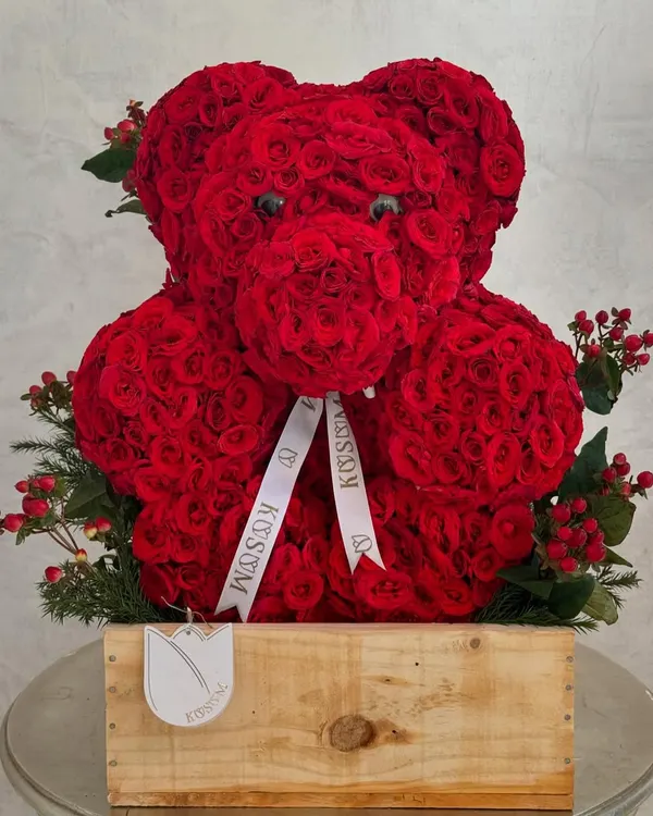 This floral teddy bear is meticulously crafted from hundreds of individual red roses. It's a popular choice for romantic occasions and proposals, offering a unique and sculptural alternative to a traditional bouquet.
