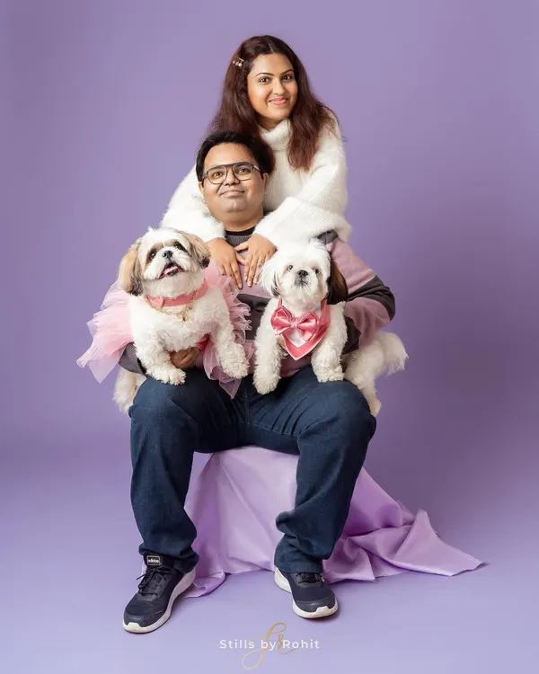 This family portrait is so full of personality! The coordinating purple and white outfits against the lavender backdrop create a beautiful, cohesive look. It shows how a little planning can lead to a stunning studio result.
