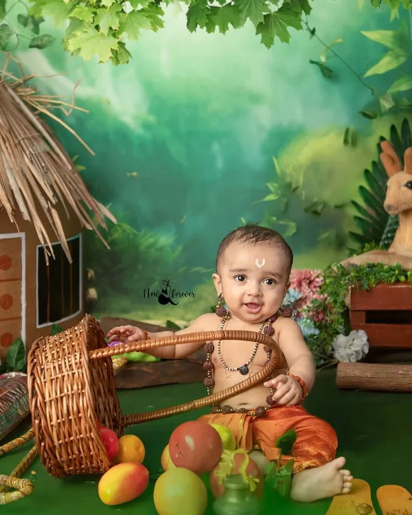 A joyful little Lord Ram playing with a basket of fruits during our Ram Navami themed shoot. The set includes a handmade hut and a forest backdrop to recreate the story.
