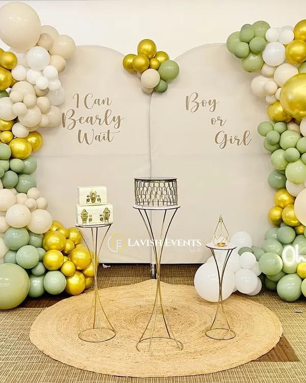 "I Can Bearly Wait!" A sweet teddy bear themed gender reveal party. The soft green, gold, and cream balloons create a neutral and elegant look for the "Boy or Girl?" surprise.