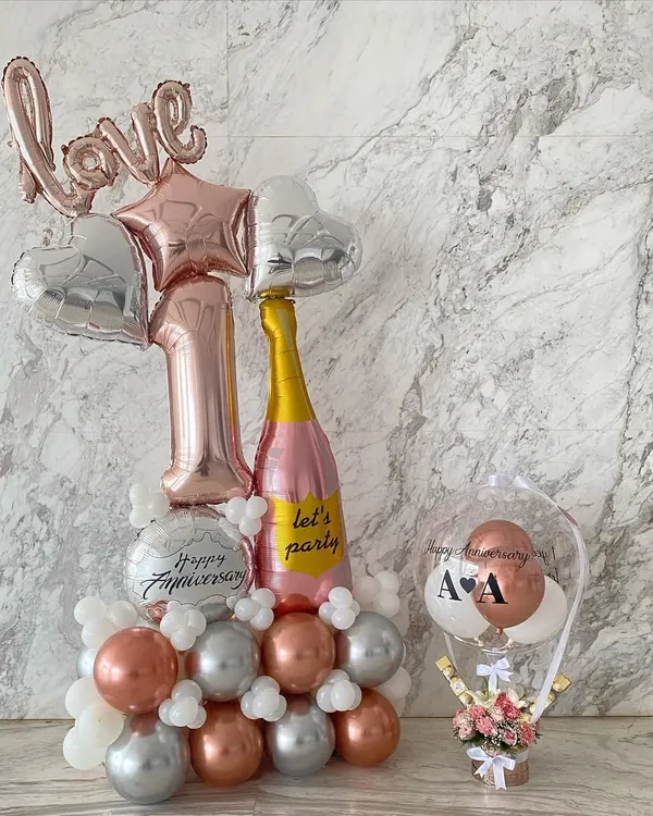 The perfect surprise for a first anniversary. This set includes a 6-foot-tall balloon arrangement and a custom hot air balloon gift basket filled with fresh flowers and chocolates.