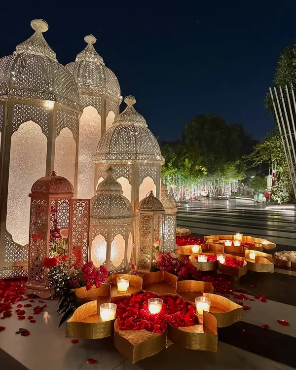 Our signature Moroccan decor. Here, grand white lanterns are combined with beds of red roses and candles, creating a bold and beautiful entrance.