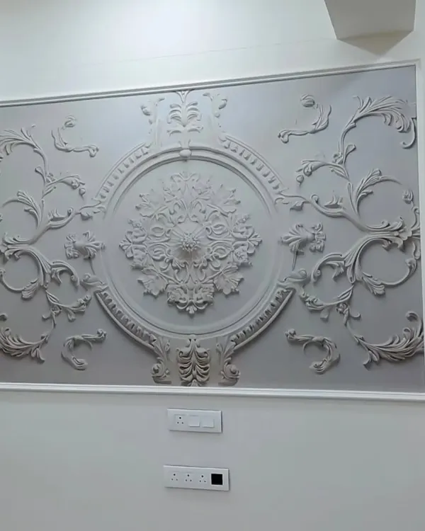 This framed 3D wallpaper features an ornate, classical design. It acts like a piece of sculpted art, adding a touch of European elegance to the room.