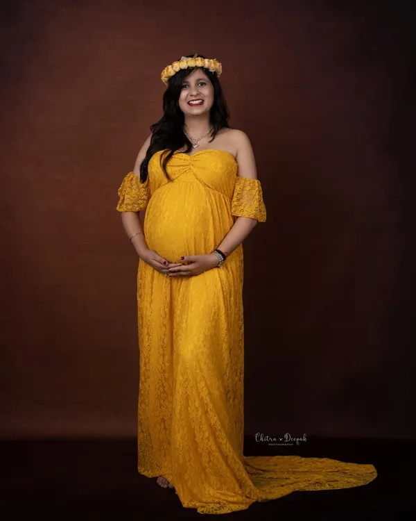 A vision in yellow. This simple, elegant lace gown and floral crown create a beautiful, bohemian-inspired look against a classic brown backdrop.