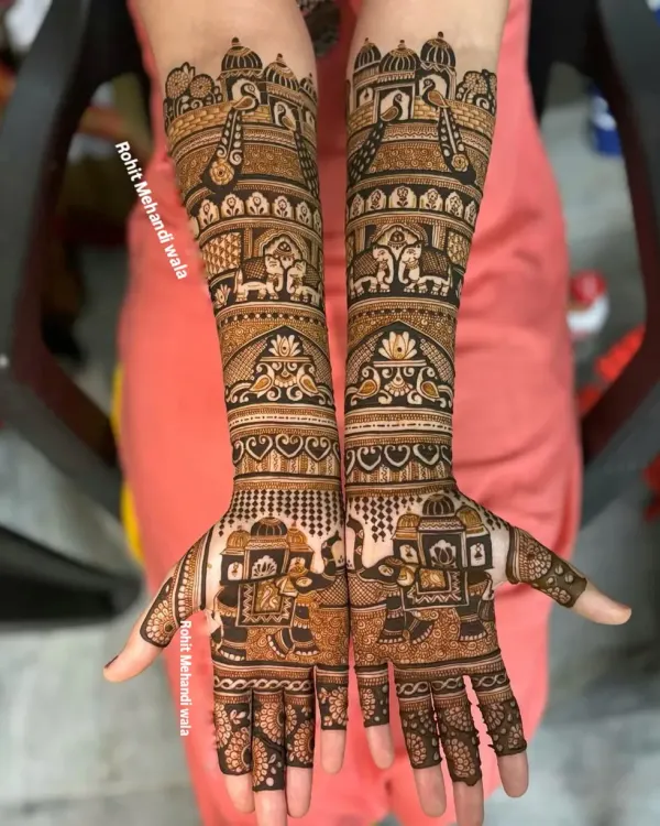 This is the kind of full-arm bridal mehandi I love to create. It features traditional Indian wedding themes, including intricate palanquin (doli) and elephant motifs, covering the arms from elbow to fingertips for a complete bridal look.