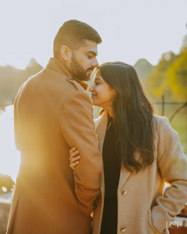 A couple shares an intimate moment, backlit by the golden hour sun during their pre-wedding shoot in Delhi. We use natural light to create warm, romantic couple portraits.