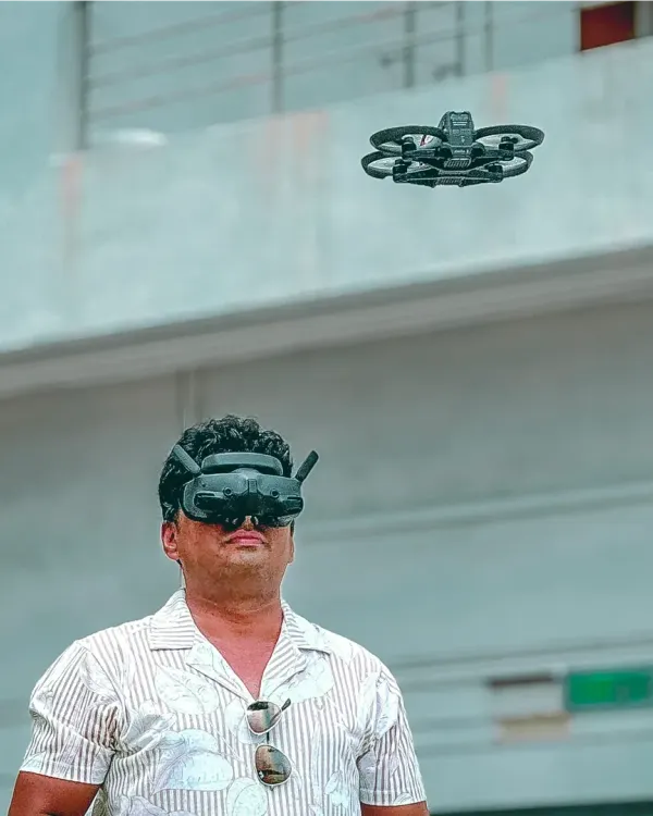 Here I am, piloting my FPV drone with goggles for a first-person view. This shows the advanced, DGCA-certified technology I use to get those immersive, dynamic fly-through shots that make my videos stand out.