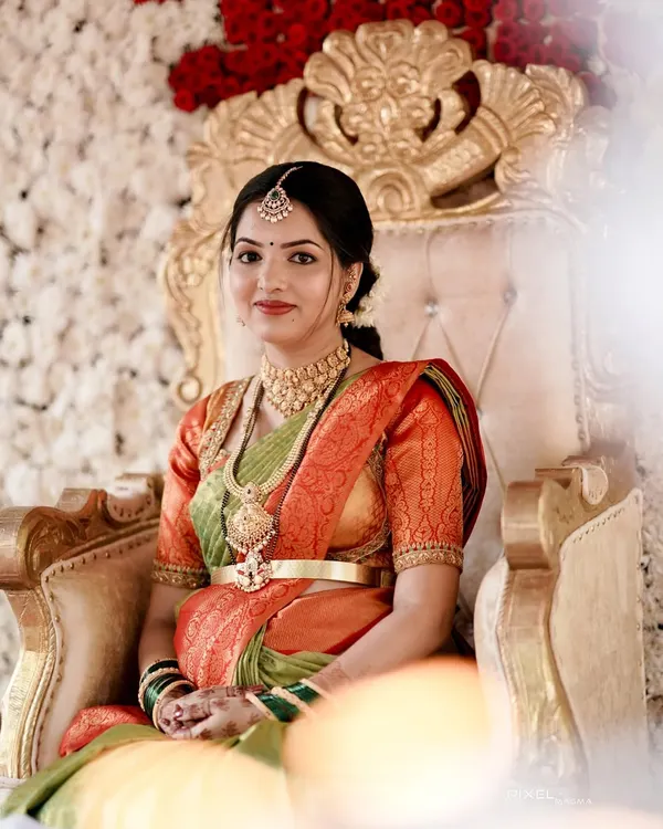 A beautiful mother-to-be at her seemantham ceremony. She is wearing a classic temple jewellery choker and haram set that radiates elegance.