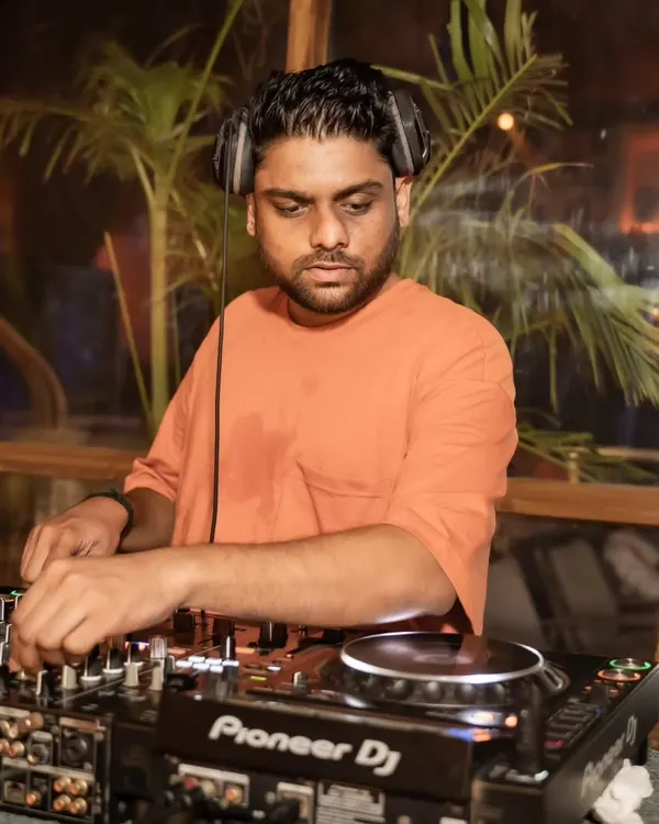 Mixing a deep house set as the sun goes down. The palm trees in the background add to the perfect sundowner atmosphere.