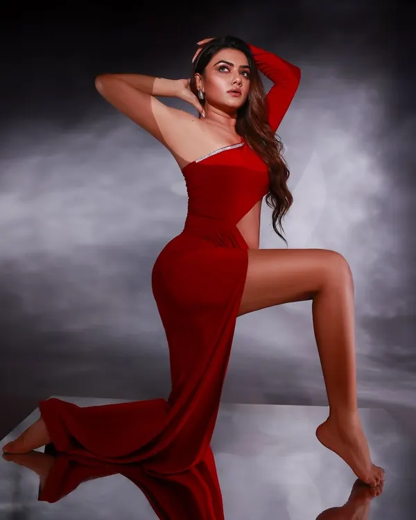 A powerful studio portrait using a mirror and a bold red theme to create a striking, high-fashion look. The reflection adds depth, making the image dynamic and memorable.