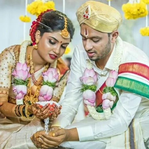 This is a beautiful moment from a traditional Gowda wedding, showing the Dhare ritual. I help my clients plan their weddings to ensure our sacred traditions are perfectly observed.